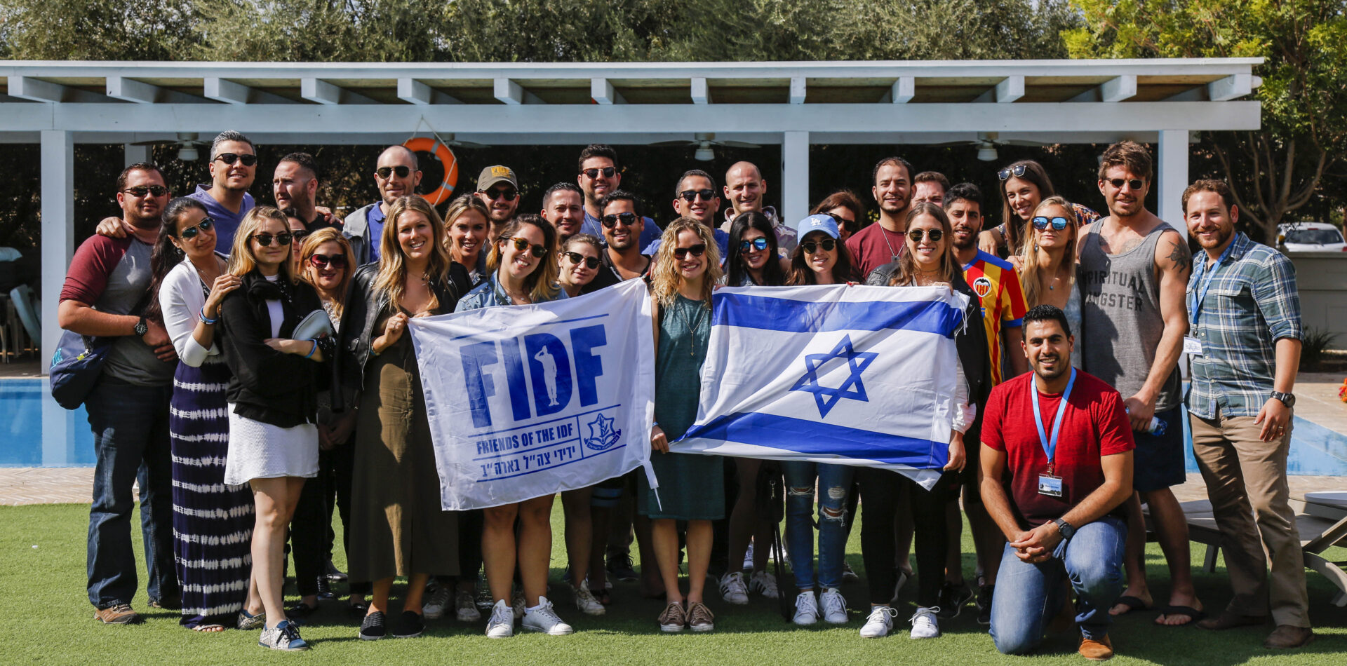 a group of young leadership holding their flag